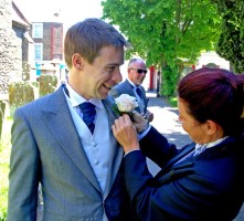 Lady Toastmaster attaching Groom's button hole